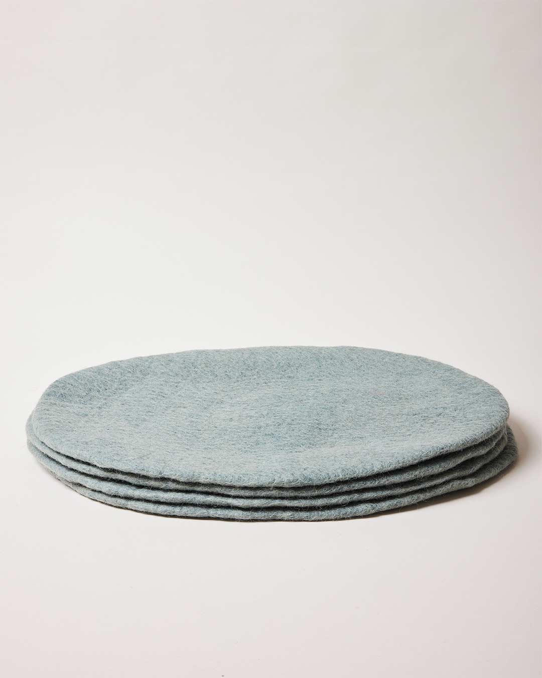 Farmhouse Pottery artisan felt placemats in teal.